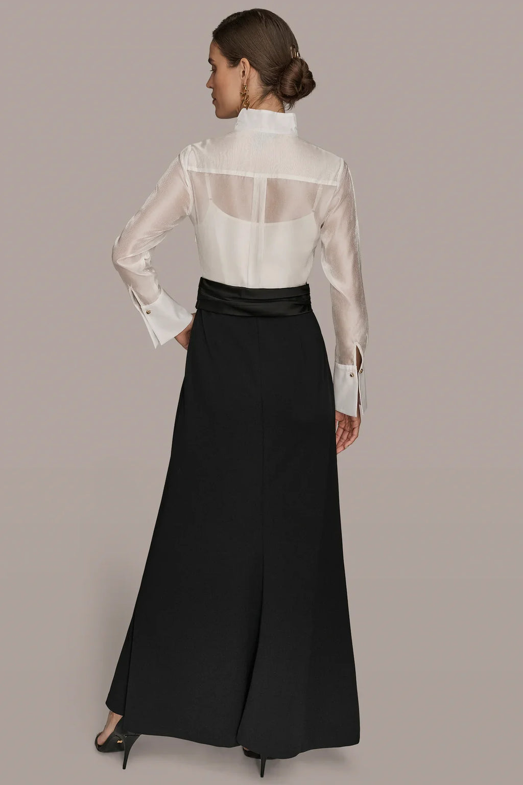 Layered wrap tuxedo evening gown featuring a sheer pleated bodice, perfect for formal occasions and elegant events. 2