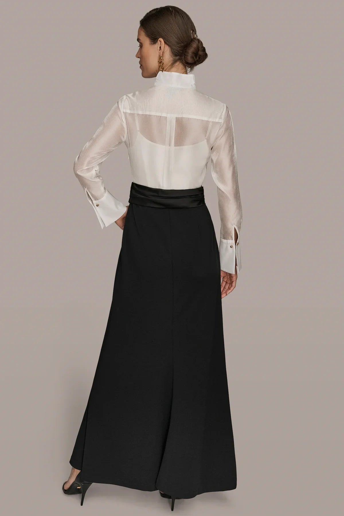 Layered wrap tuxedo evening gown featuring a sheer pleated bodice, perfect for formal occasions and elegant events. 2