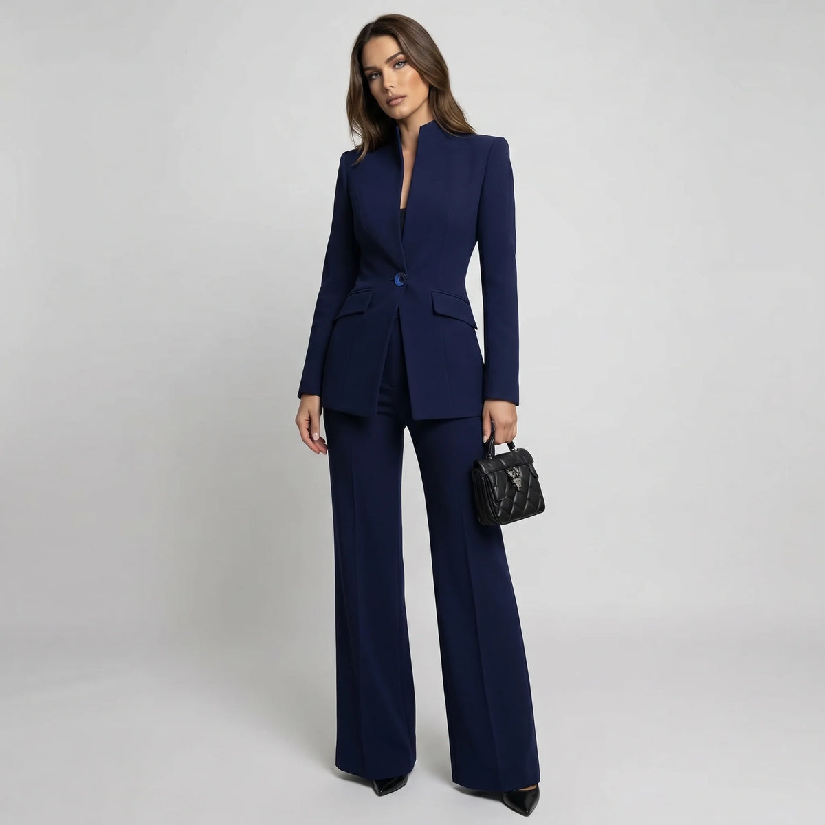 Tailored women's suit set featuring a stylish high collar blazer and elegant wide-leg trousers, perfect for professional and formal occasions. 0